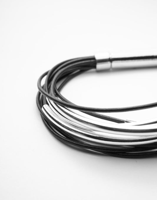 Multi Strand Black Leather Bracelet . Sterling Silver Tubes . Stainless Steel Closure