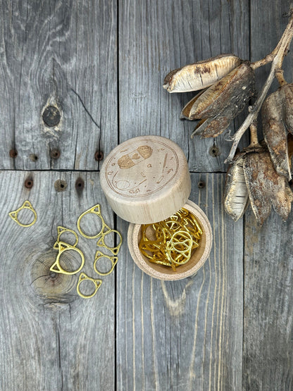 Knitting stitch markers . 30 gold colored cat stitch markers in a wood box