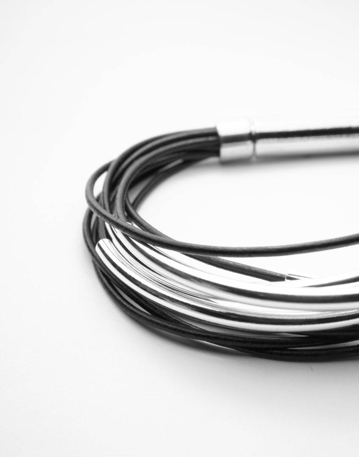 Multi Strand Black Leather Bracelet . Sterling Silver Tubes . Stainless Steel Closure