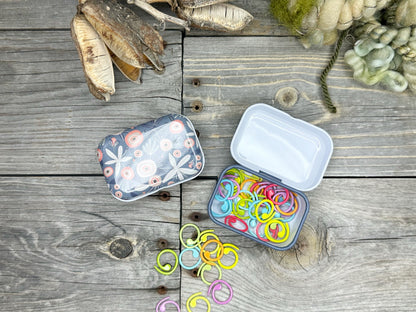 Knitting and crochet stitch markers . 30 assorted stitch markers in a collectible tin box